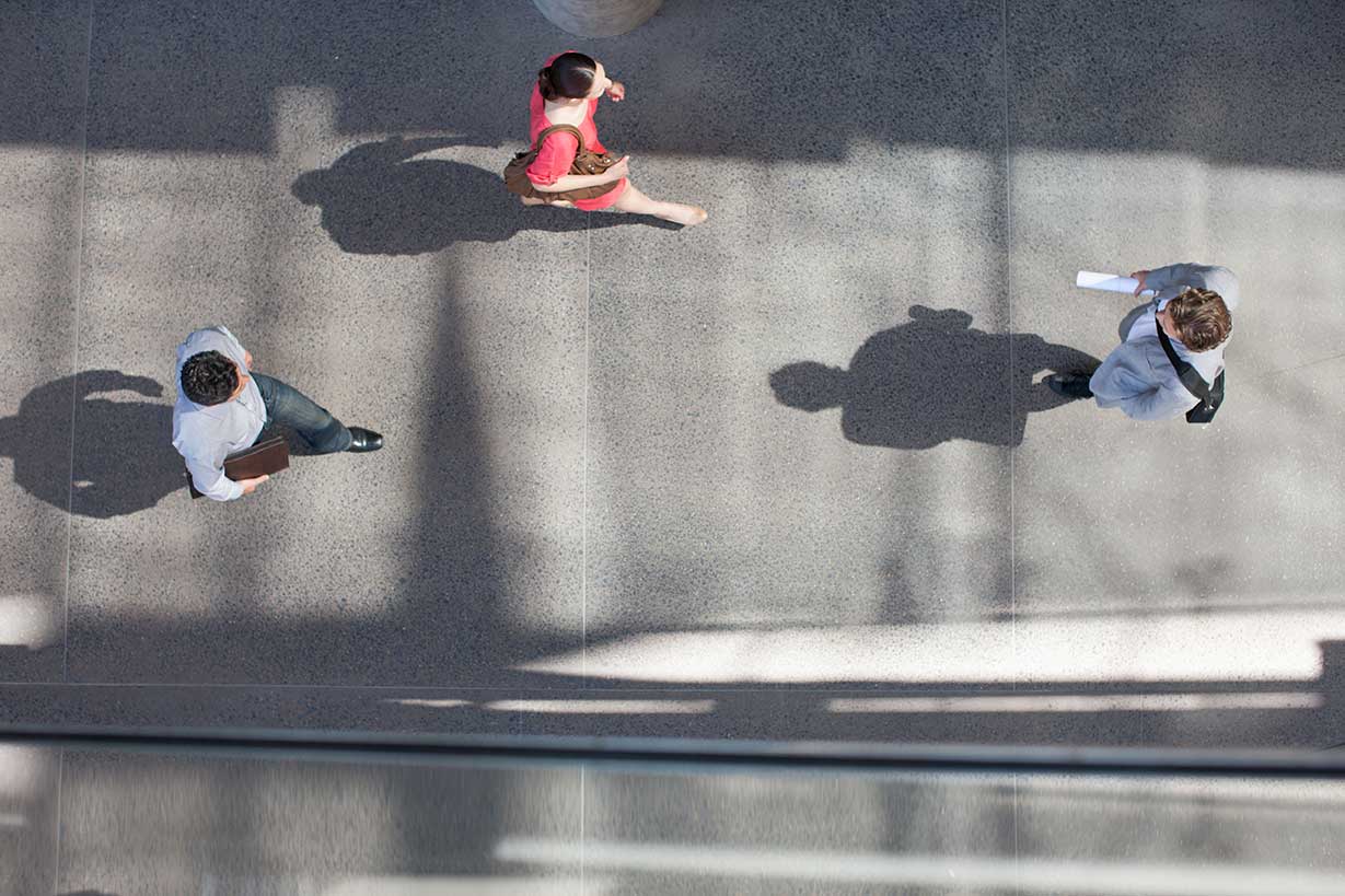 Aerial view of pedestrians on a sidewalk walking