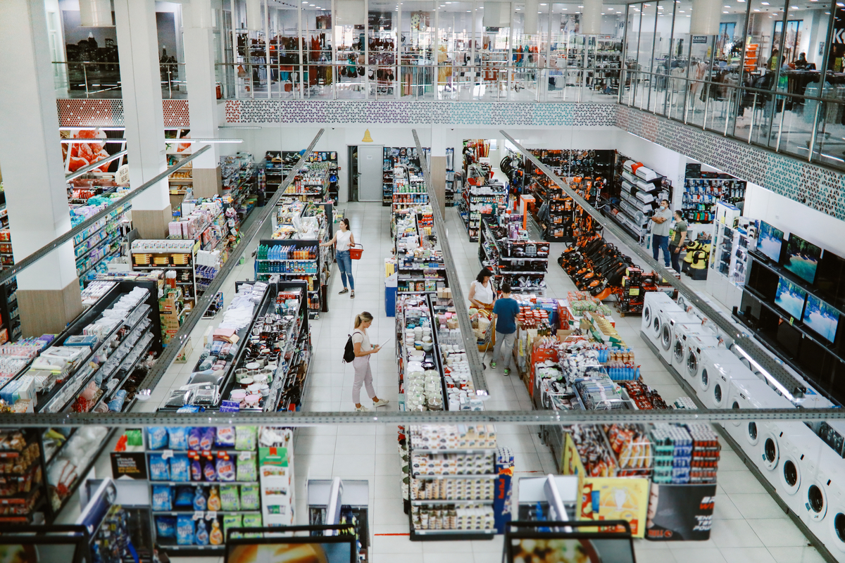 Overhead image of consumers buying in the large supermarket.