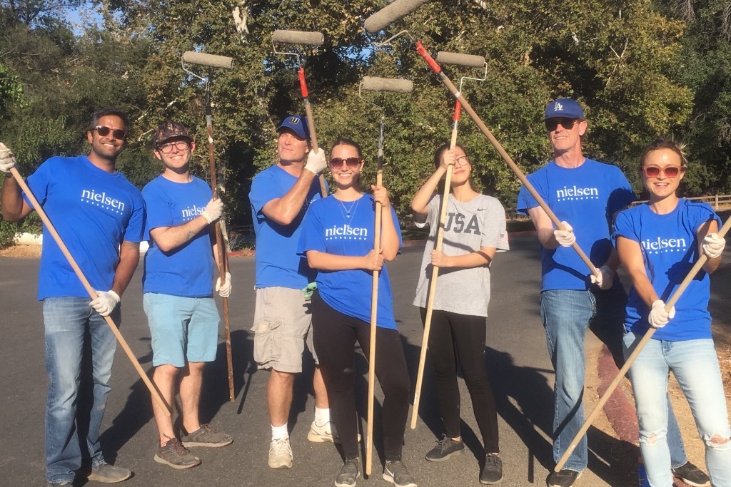 Nielsen volunteers paint. 