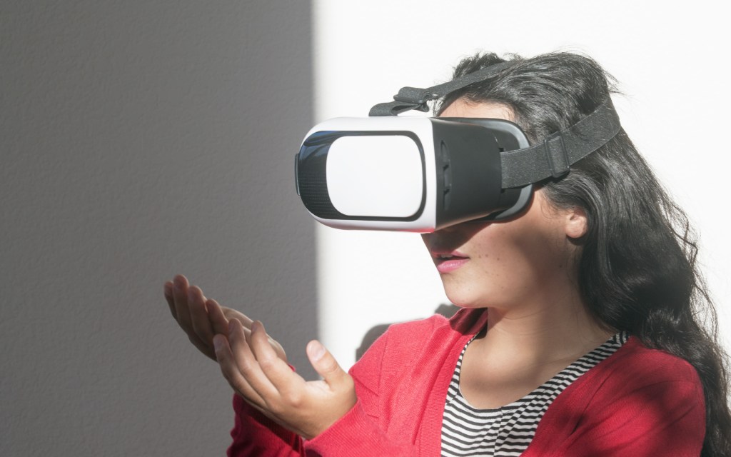 young woman wearing virtual reality head set