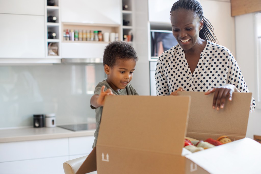 Mother And Son Opening Parcel With Meal Kit