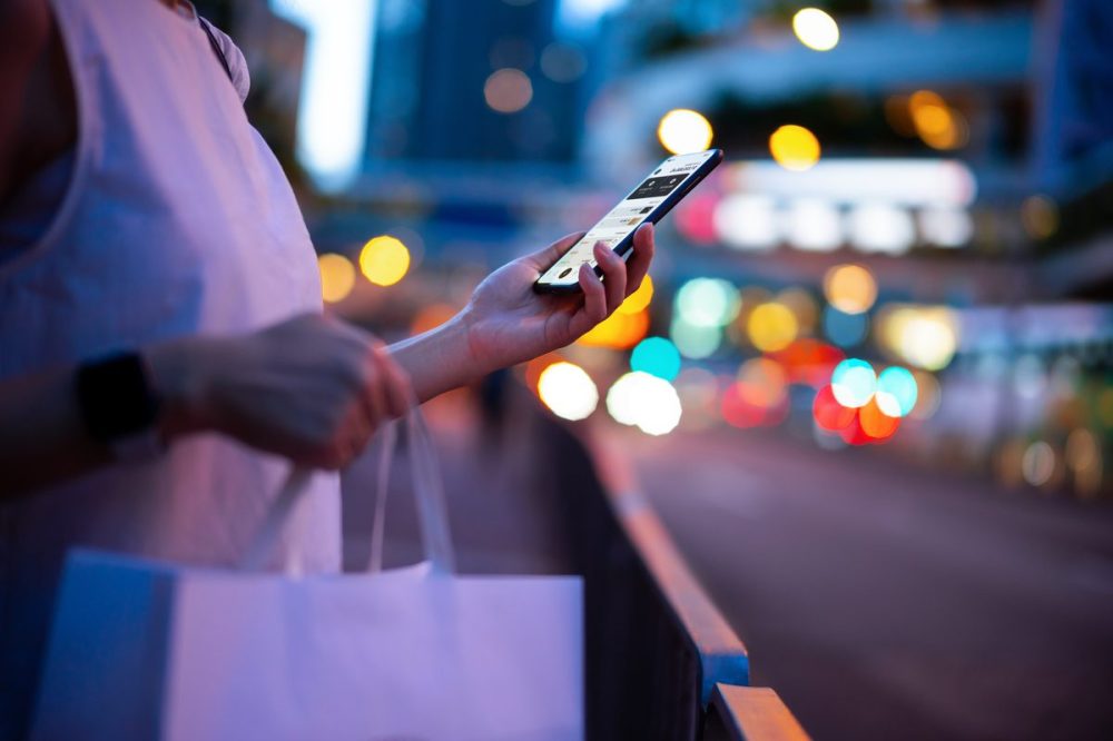 women with her phone buying stuff