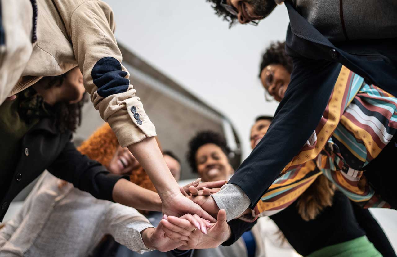 Group of people joining hands