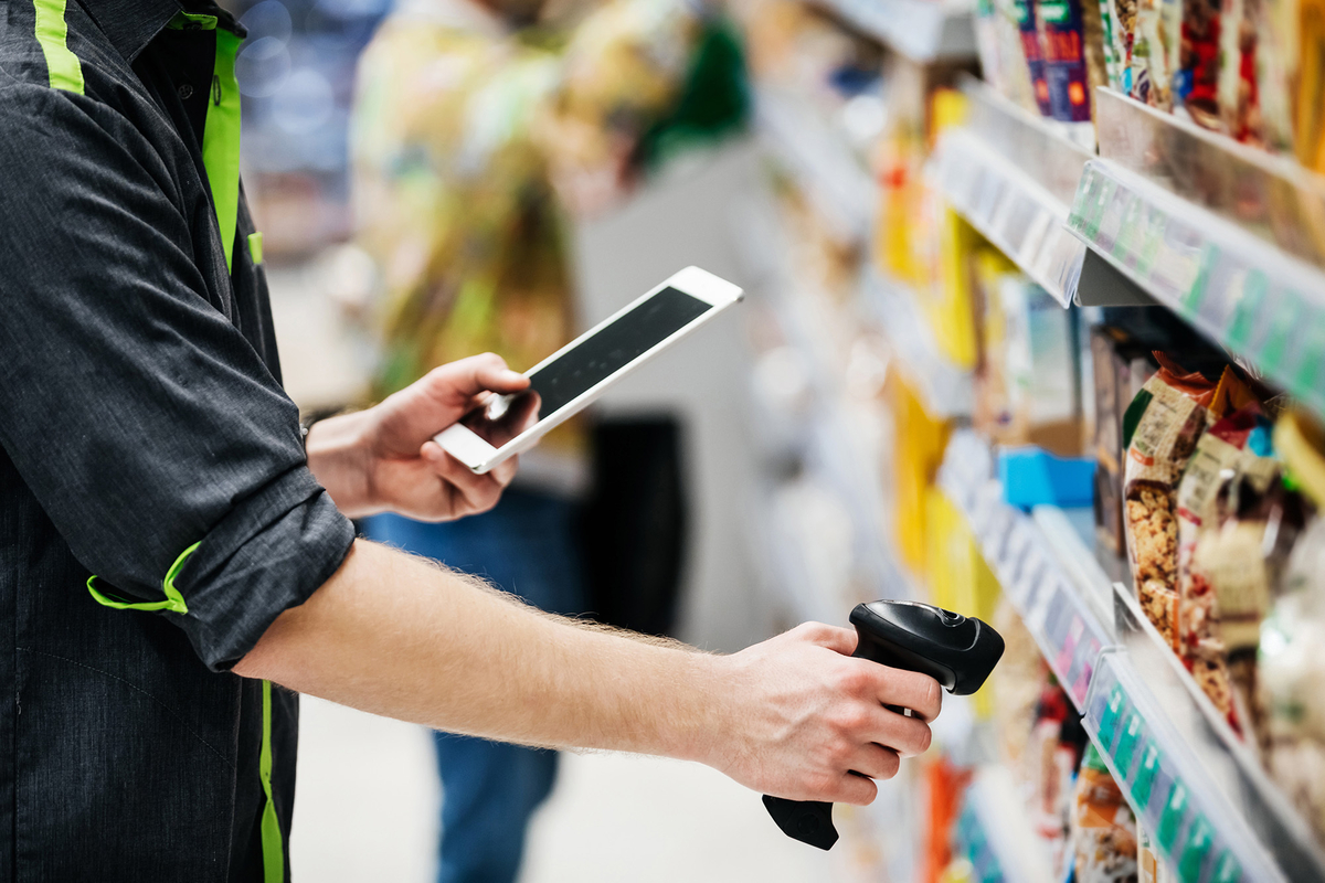 Man scanning bar code on shelf