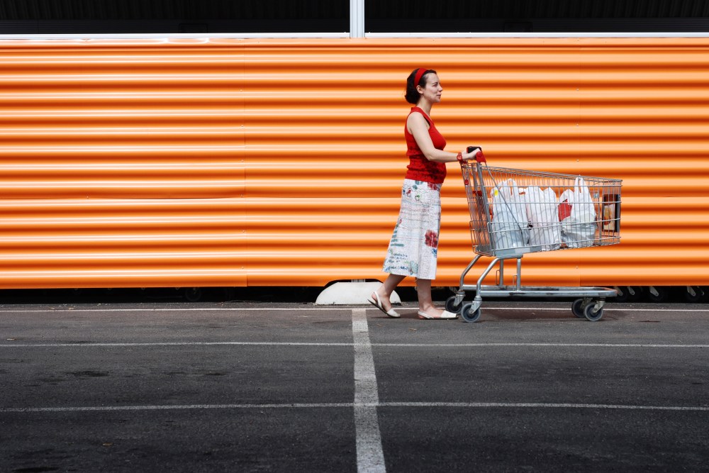 Woman pushing a shopping cart in front of a smart store