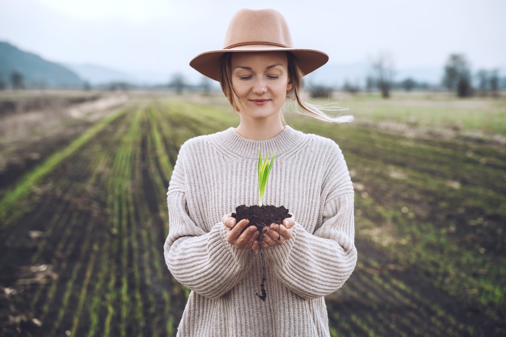 woman in field with plant