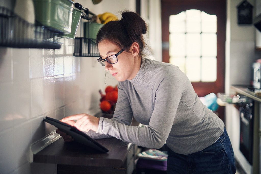 woman using a tablet to look at products online