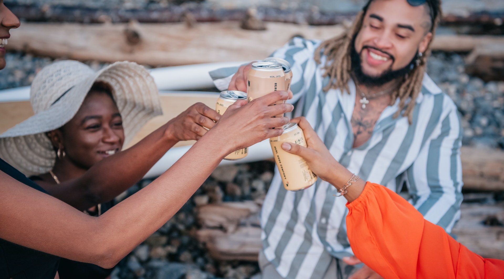Young people cheers with ready-to-drink alcoholic beverages