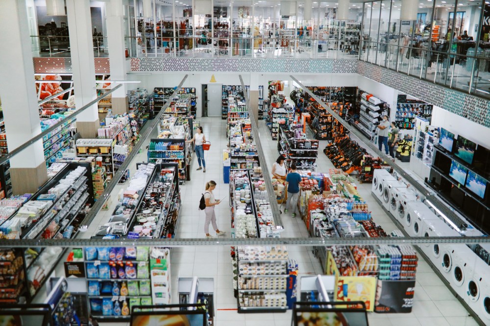 Overhead image of consumers buying in the large supermarket.