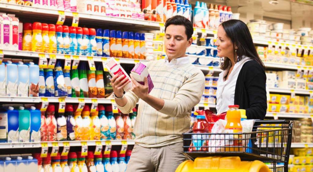 Couple examines labels on products in the dairy aisle