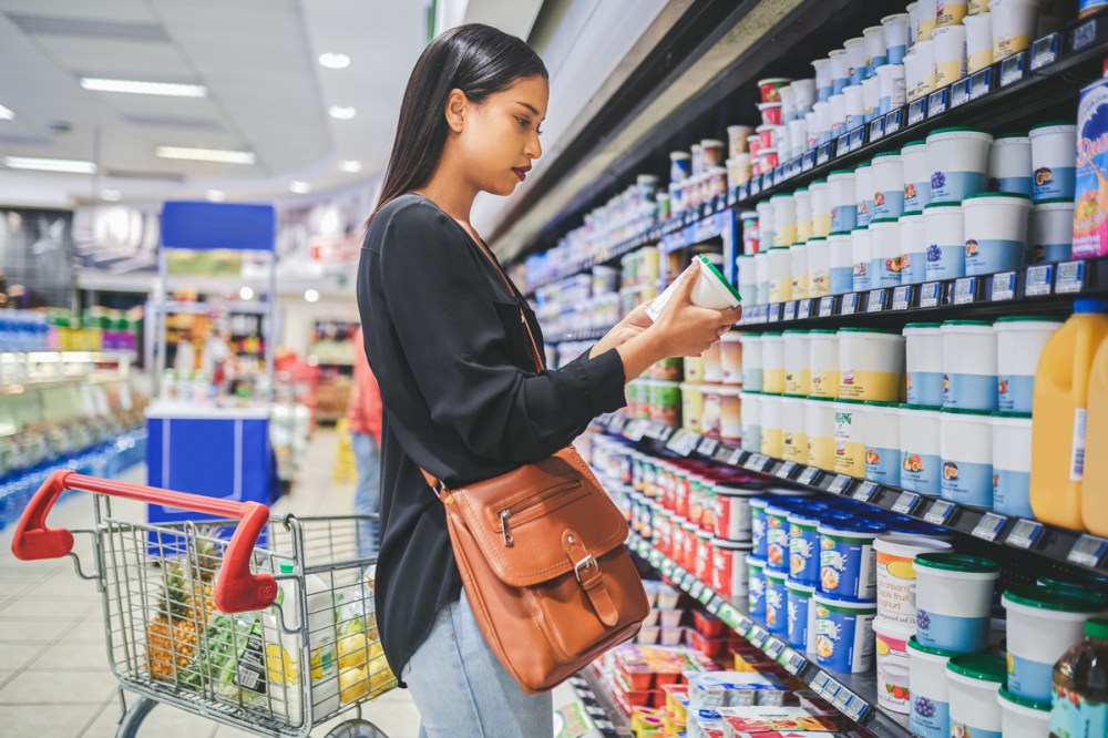A woman examining the dairy section in a store