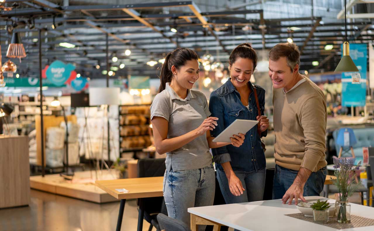 Three friends look over list at a store