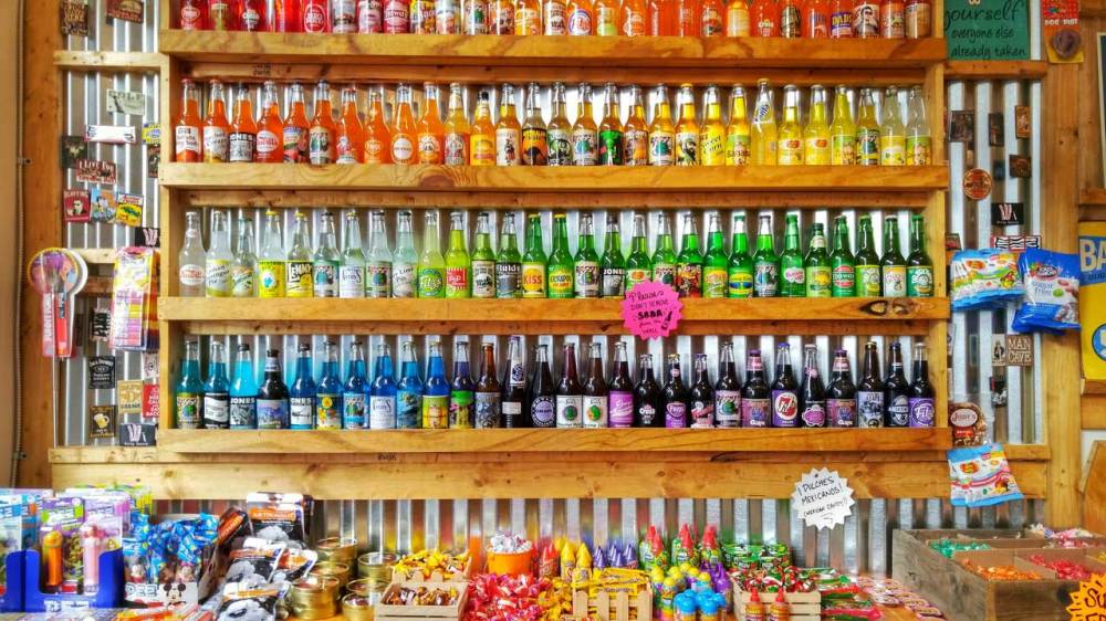 Multi-colored bottles and products on a shelf display in store