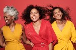 Portrait of a group of mature women against a red background