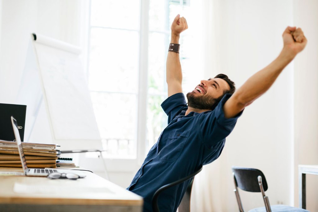 man raising his arms in exhuberance