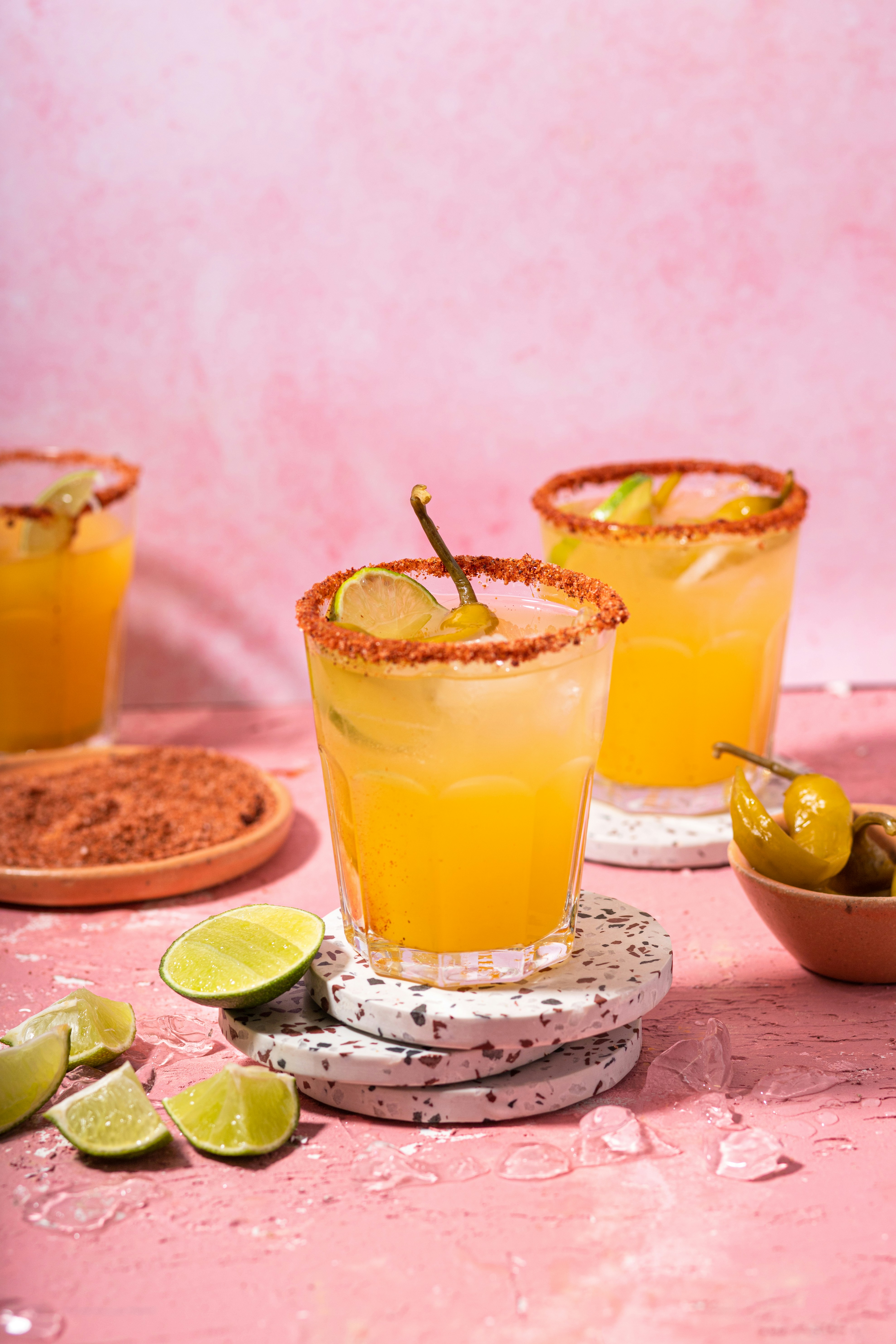 Image of tequila based cocktails with spicy rims, and lime and jalapeno garnish