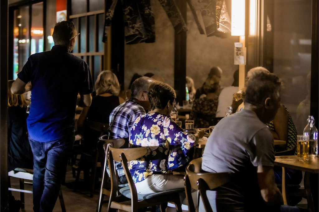 people sitting around a table at a restaurant