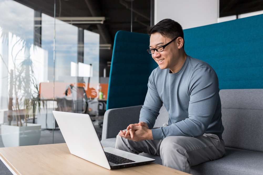 Asian,With,Glasses,,Working,In,The,Office,,Making,A,Video