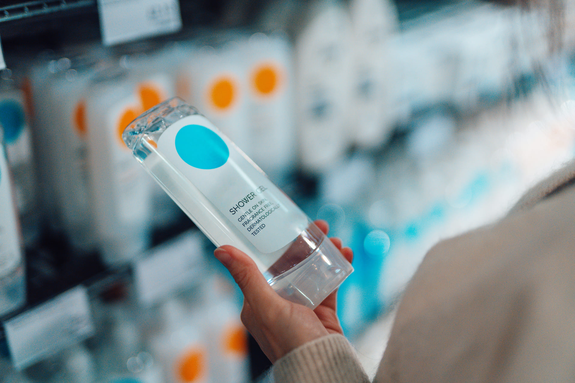 person with a shampoo bottle