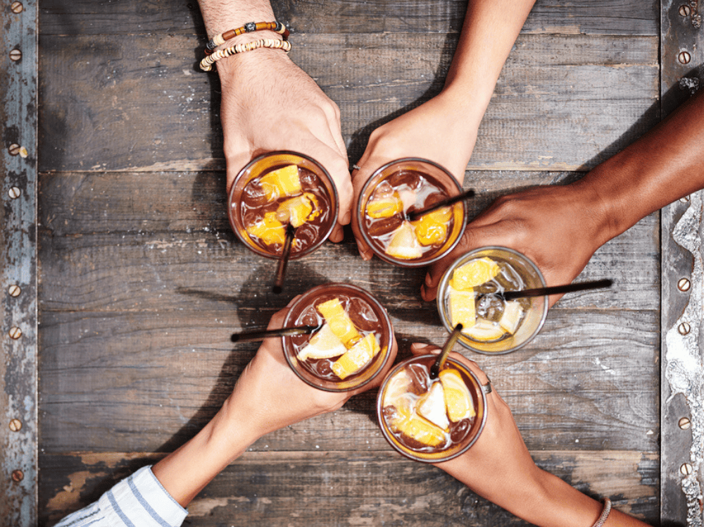 people hands in a table with a drink