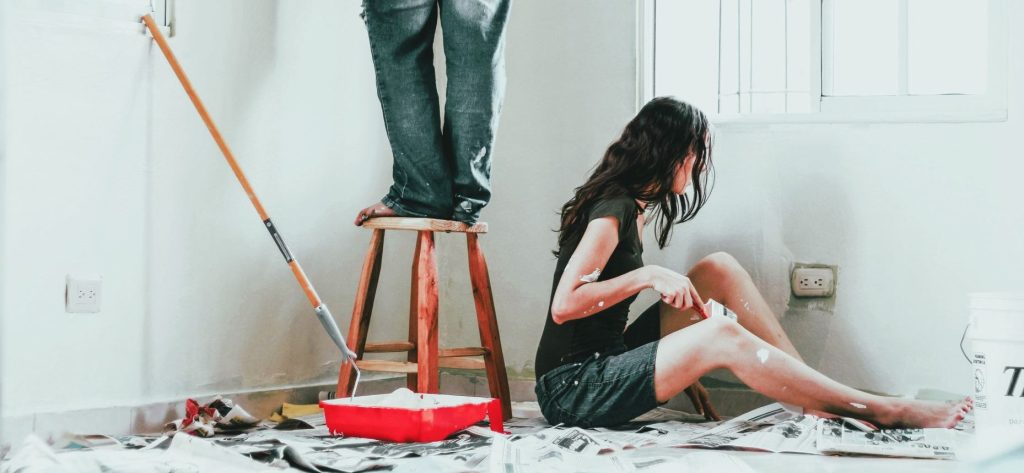 Couple refurbishing their home interior. Painting. DIY.