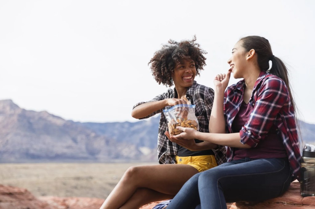 Two people snacking healthfully linked in the top 10 insights of 2025