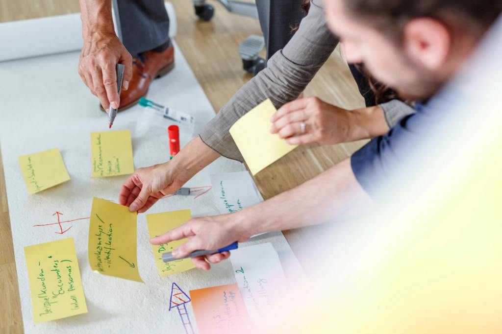 People Working over sticky notes