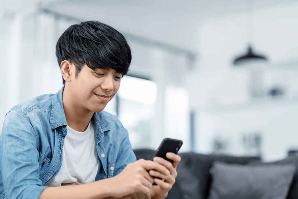 Man looking at phone, blue background