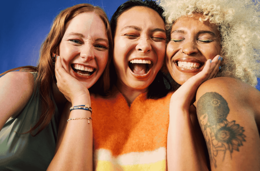 group of girls smiling in a beauty background