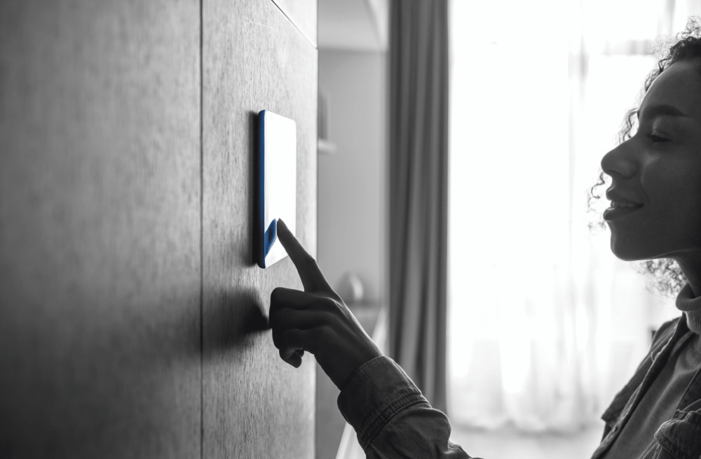Woman using a wall-mounted smart home control panel