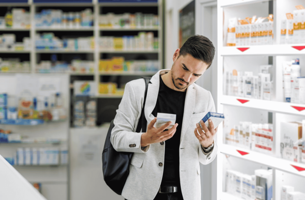 man comparing two medicines