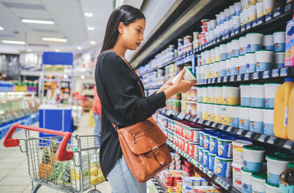 women at the supermarket looking a the packaging
